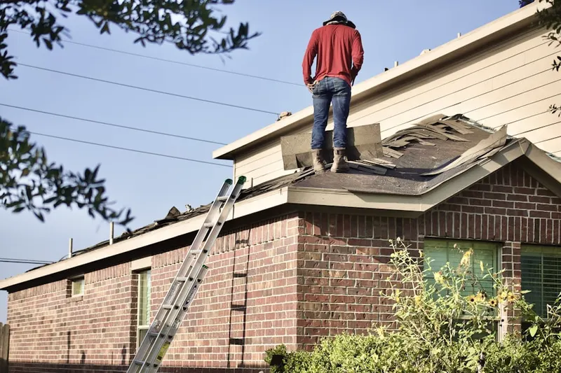 Professional roofer working on a residential roof in Huber Heights